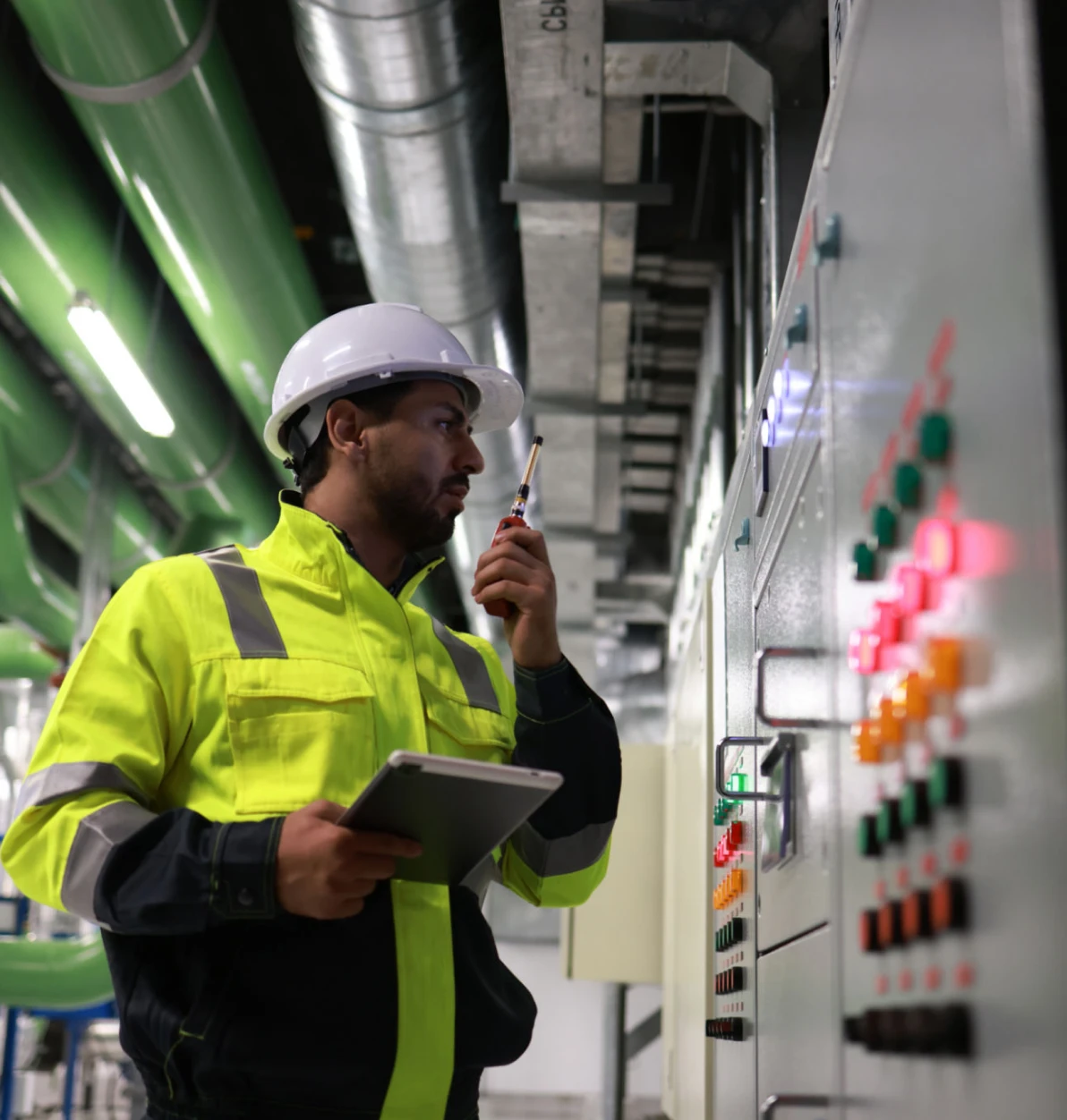 Worker checking industrial equipment settings