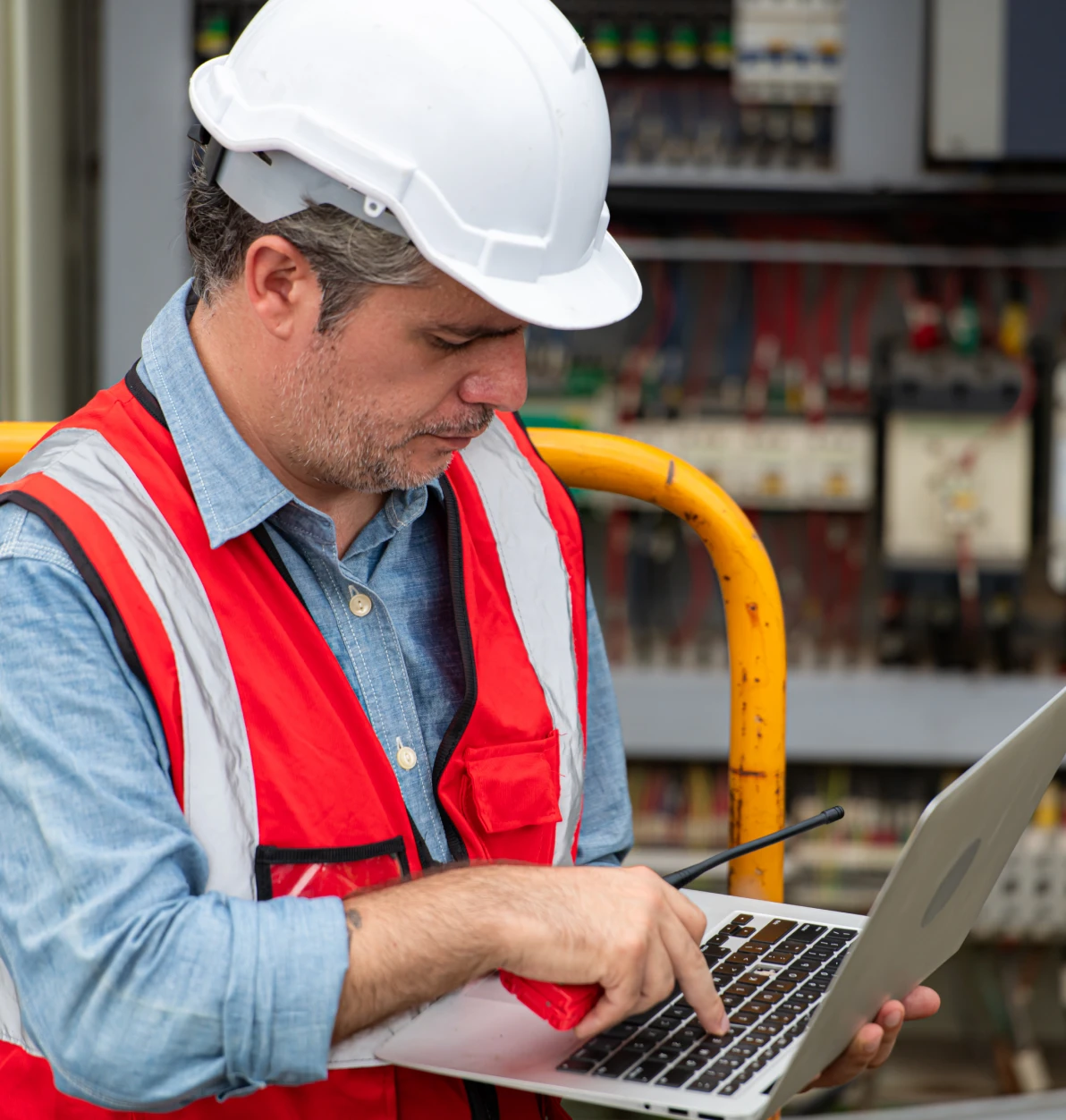 Man in hard hat working on laptop